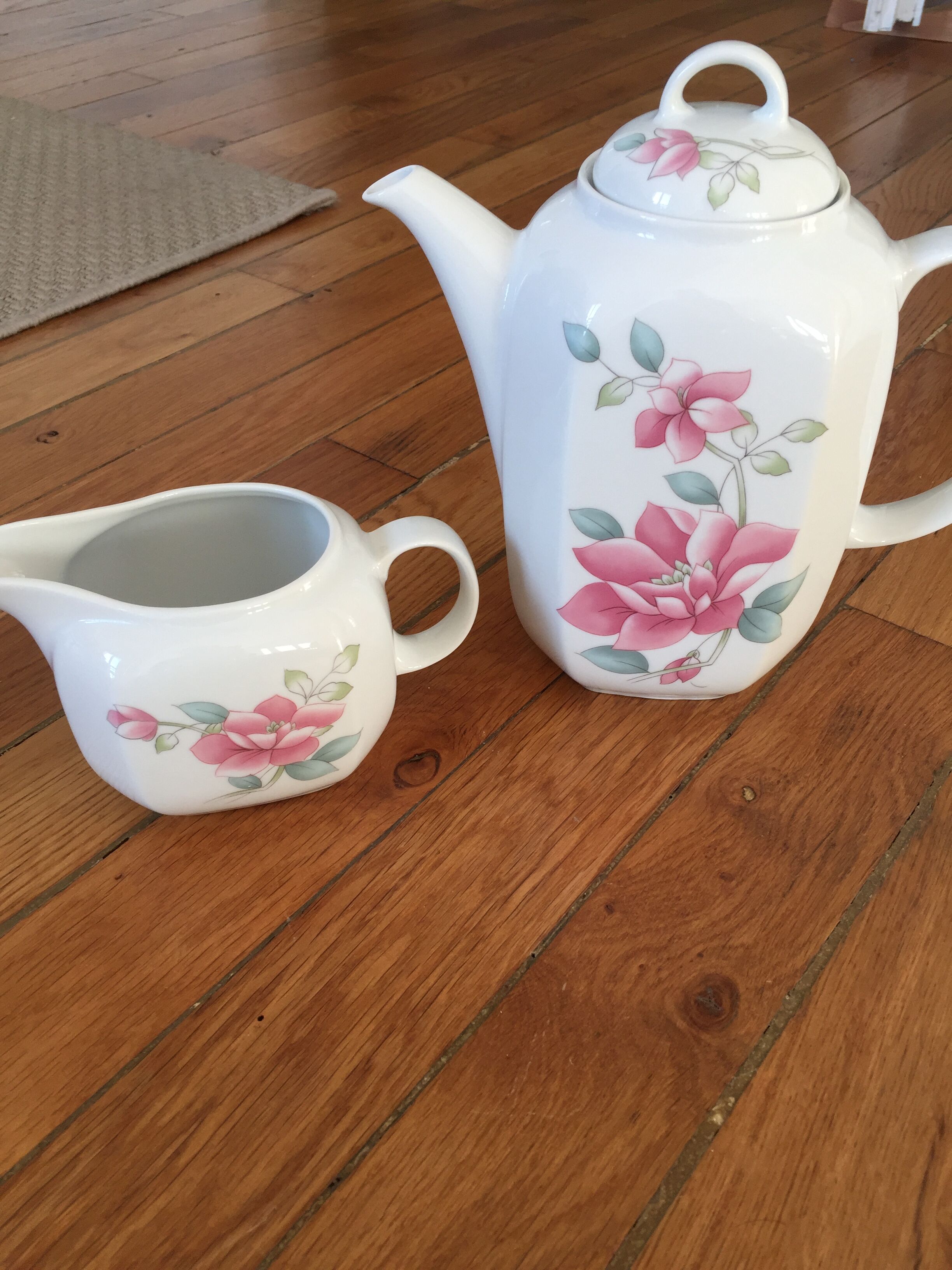 Vintage porcelain coffee or teapot with milk jug