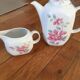 Vintage porcelain coffee or teapot with milk jug