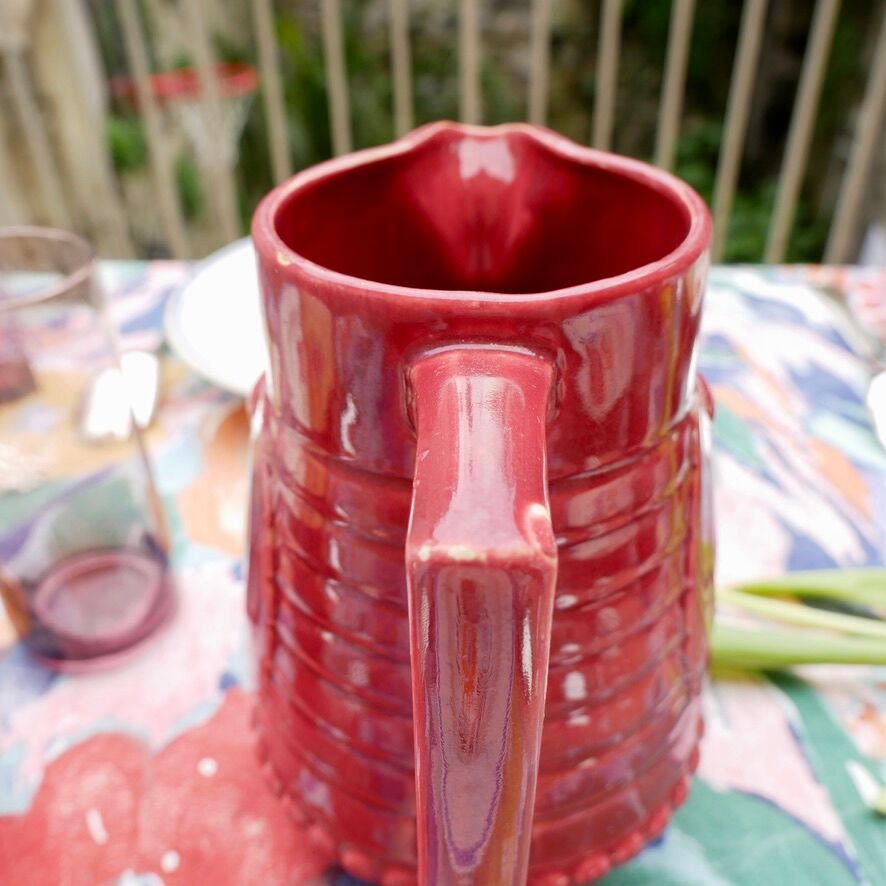Burgundy/red ceramic pitcher