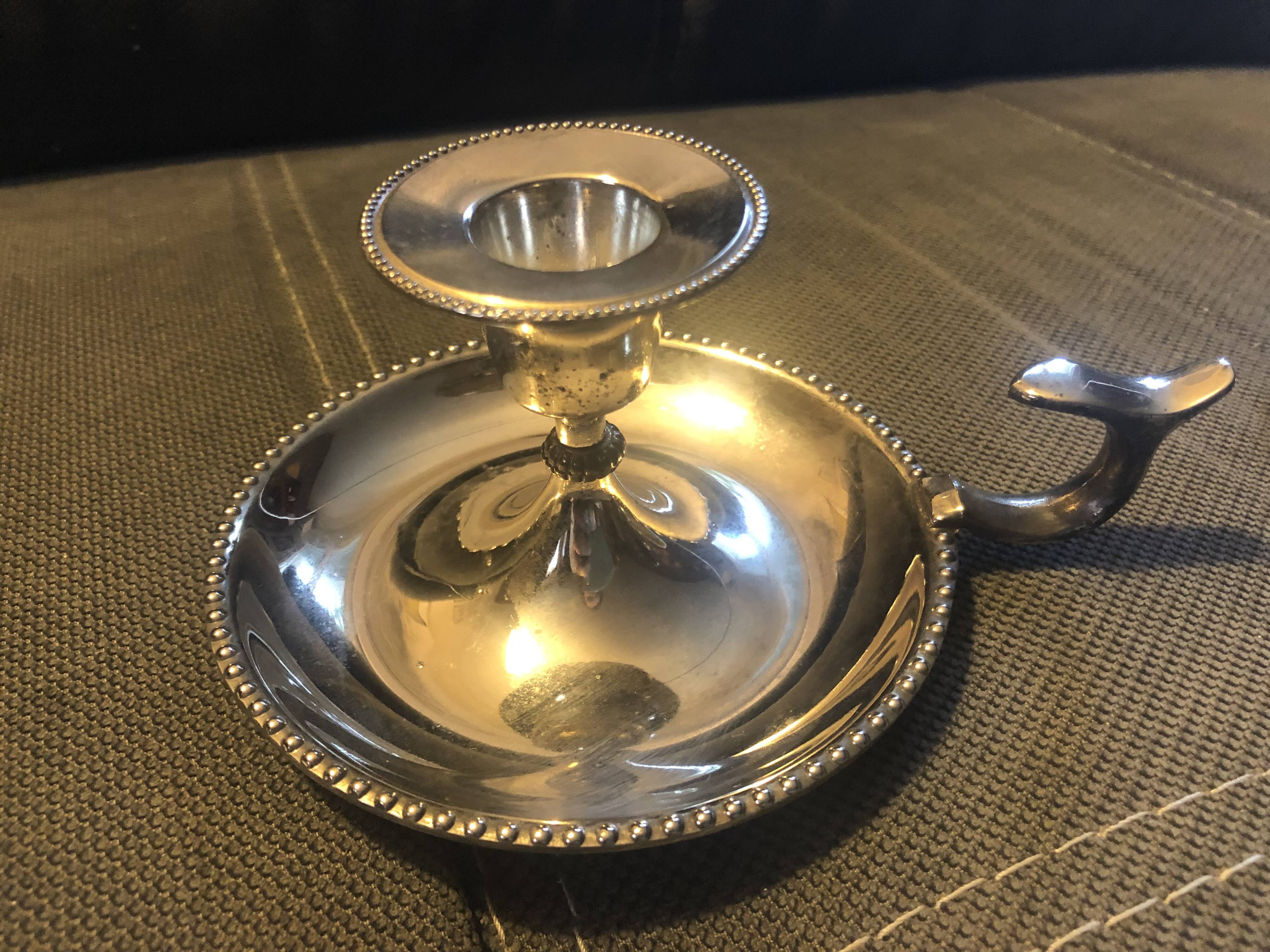 Pair of silver metal hand candle holders