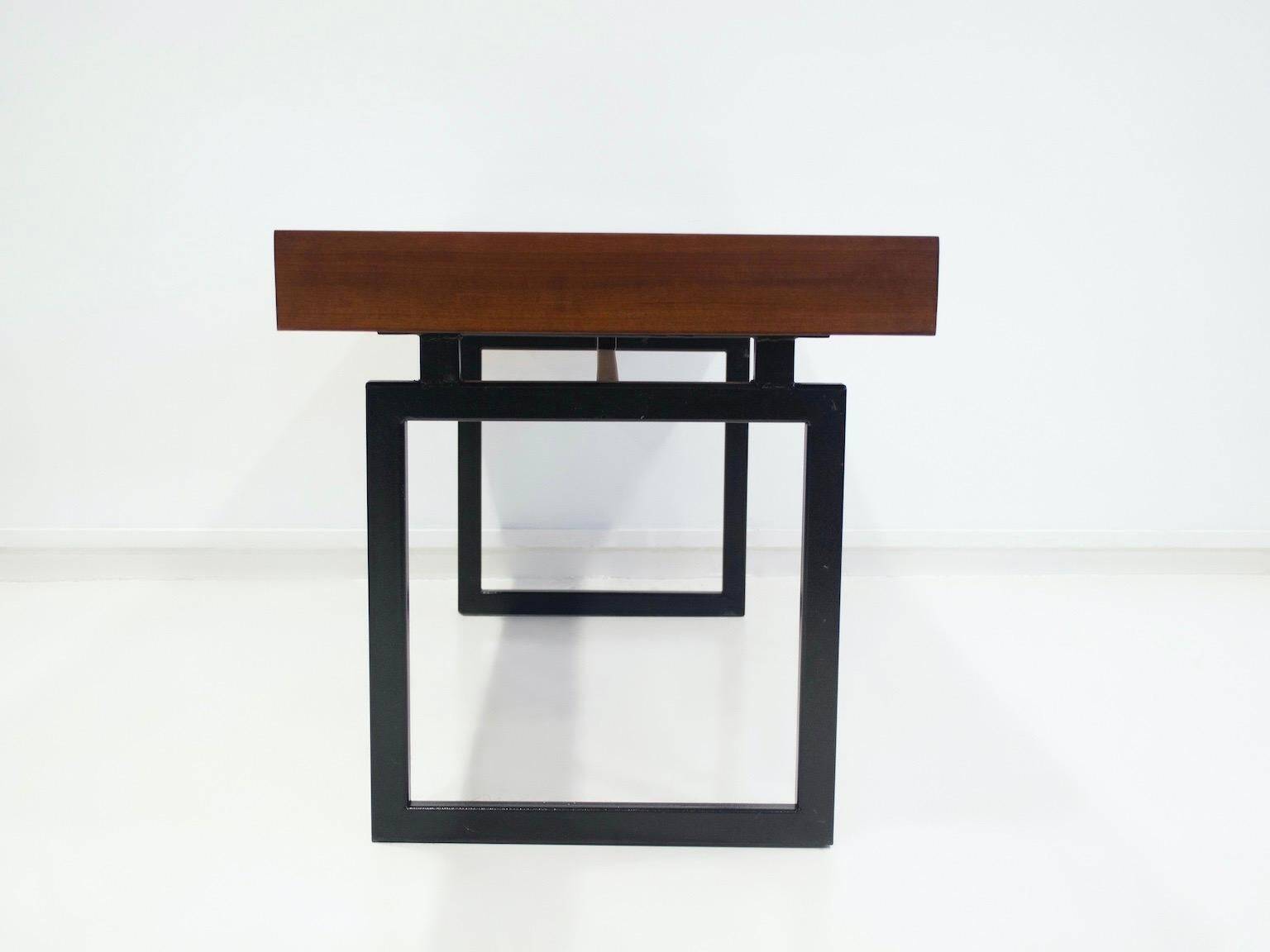 Wooden desk with drawers and black lacquered legs.