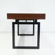 Wooden desk with drawers and black lacquered legs.