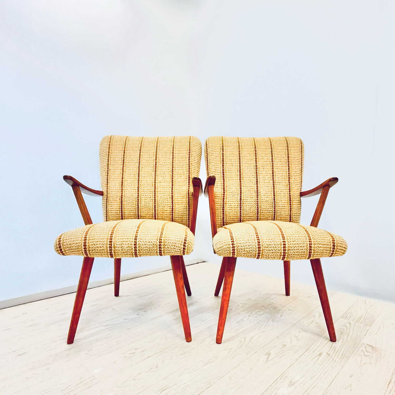 A pair vintage cocktail chairs with stripes and metal screws