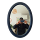 Vintage oval mirror in petrol blue wood