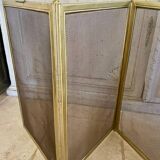 Five-panel golden metal fireplace screen from the 19th century.