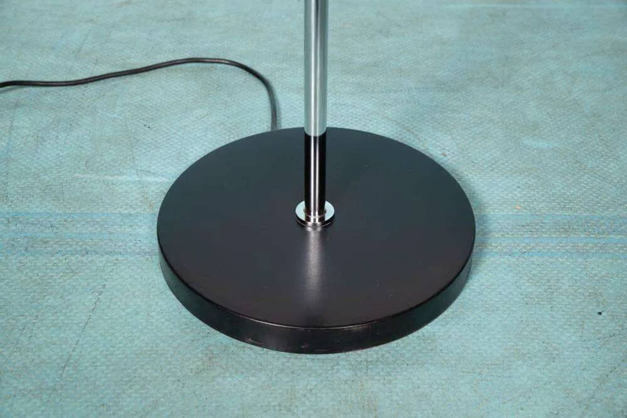 Vintage floor lamp in milky glass and chrome, minimalist uplight lighting.