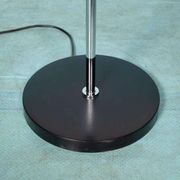 Vintage floor lamp in milky glass and chrome, minimalist uplight lighting.