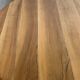 Round dining table with fluted legs in solid wood