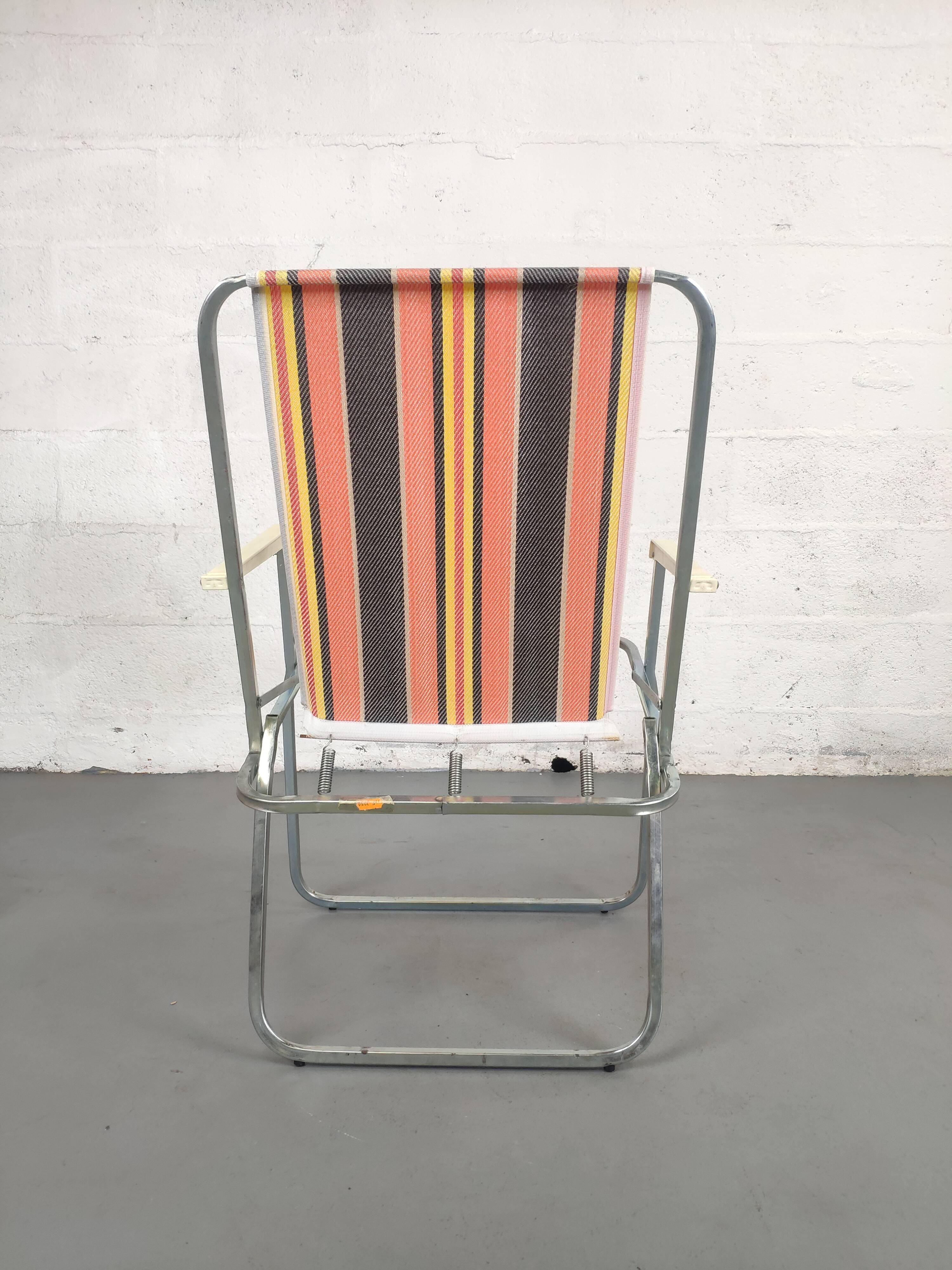 Old folding armchair seaside vintage orange black yellow