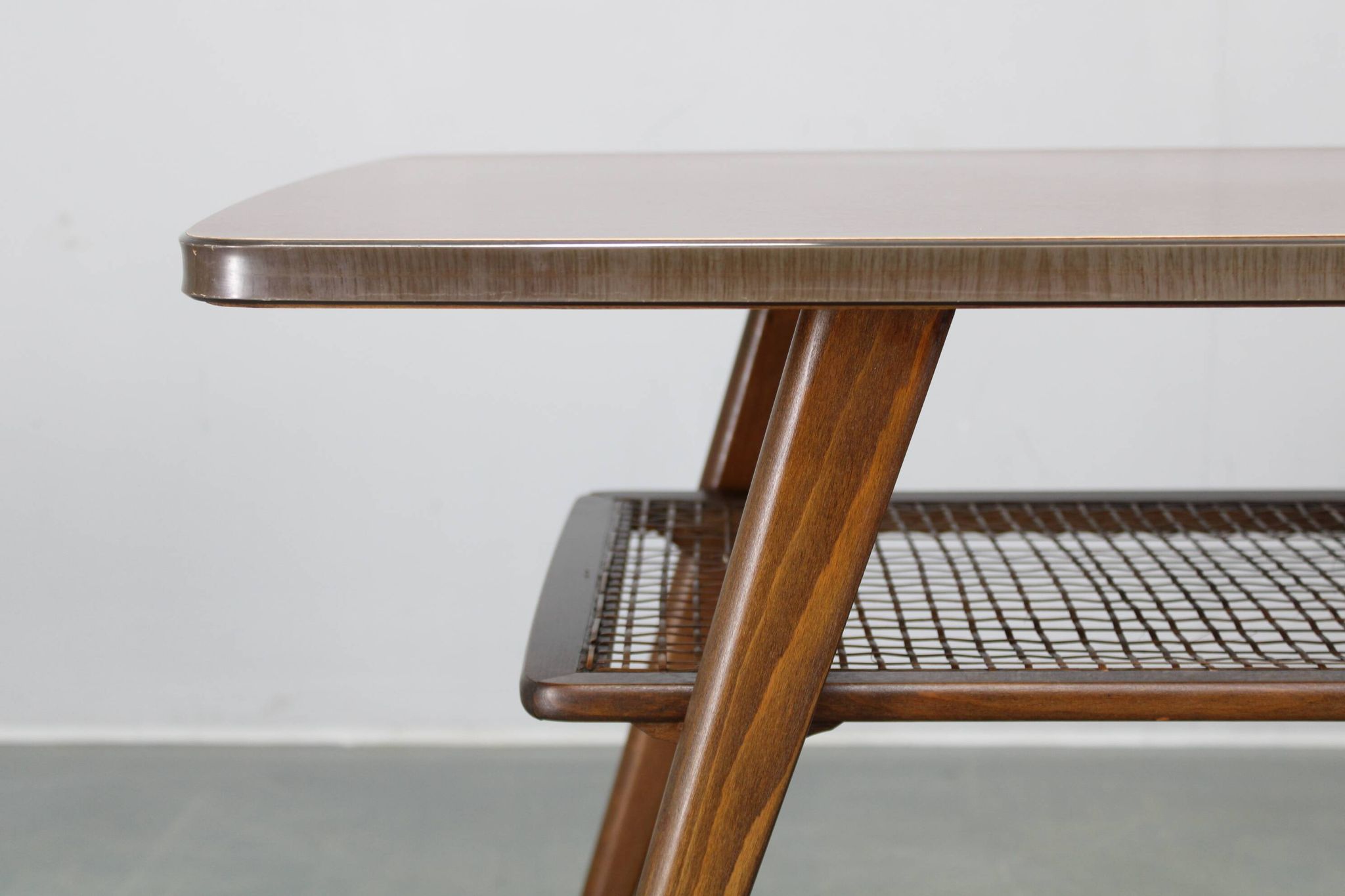 Mid-century German coffee table with rattan shelf and brass legs