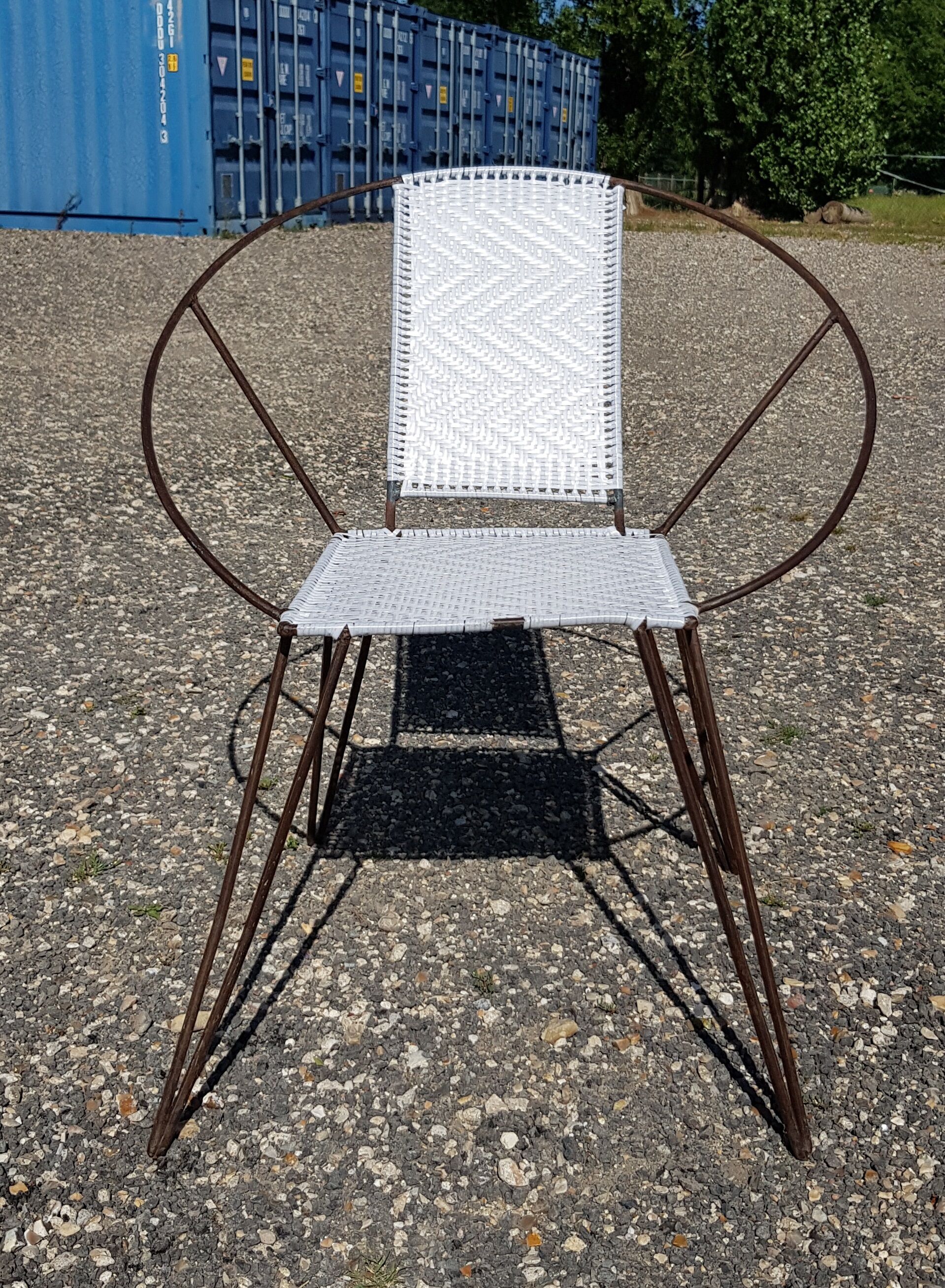 Vintage armchair in black metal and white plastic caning.