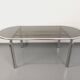 Vintage oval dining table in smoked glass and chrome metal, Space Age style.