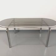 Vintage oval dining table in smoked glass and chrome metal, Space Age style.