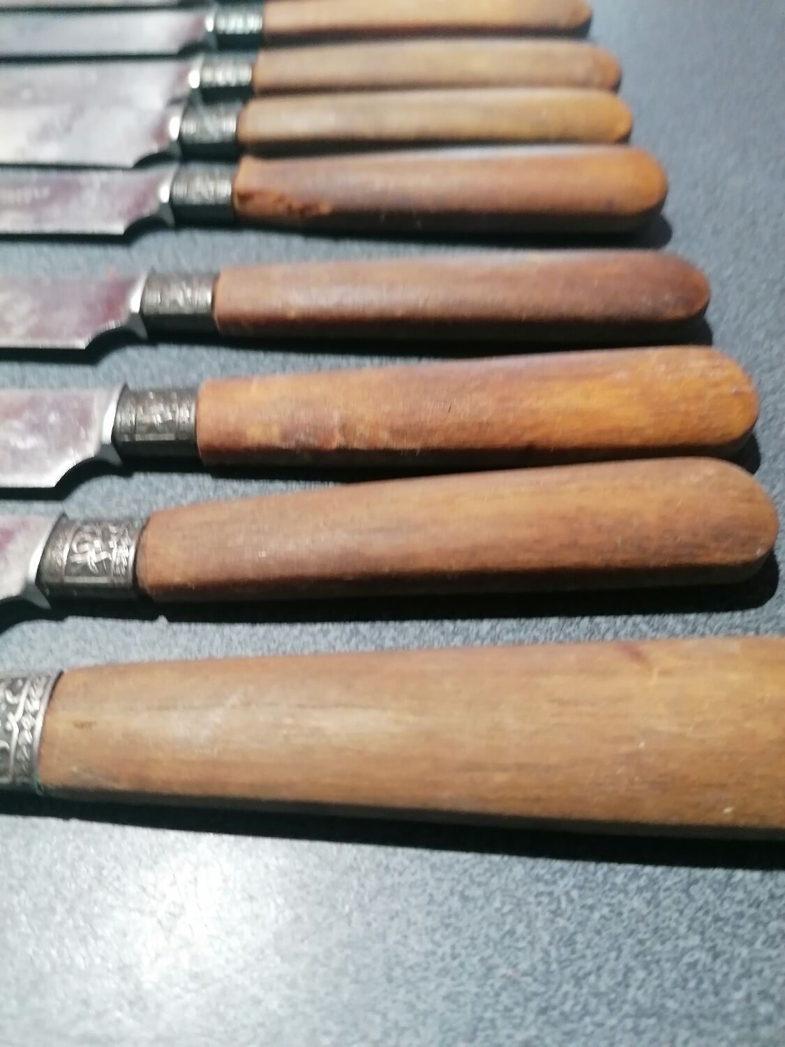 Old table knives and dessert knives, wooden handles, stainless steel blades