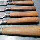Old table knives and dessert knives, wooden handles, stainless steel blades