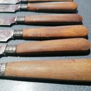 Old table knives and dessert knives, wooden handles, stainless steel blades