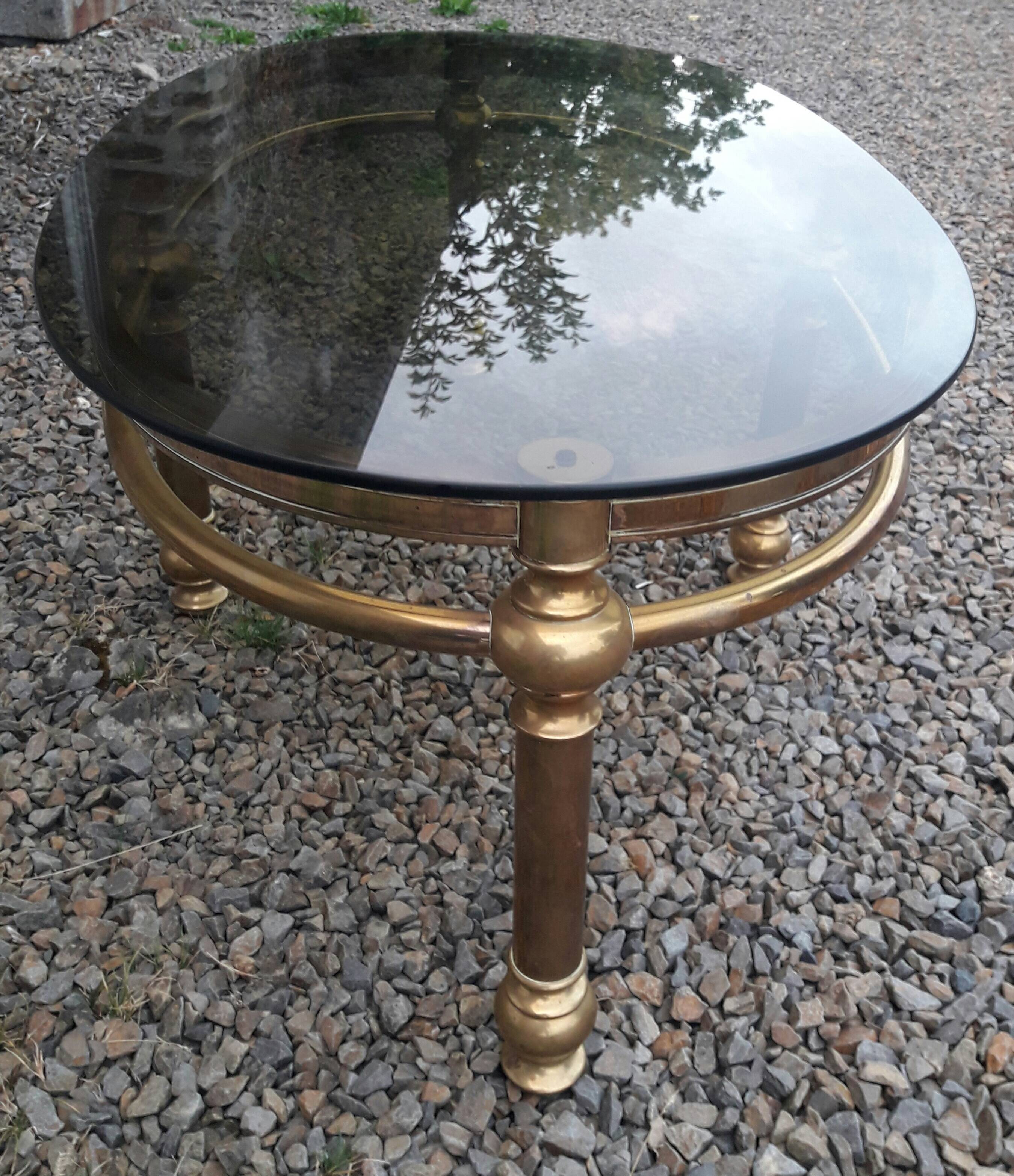 Oval coffee table in gilded brass and smoked glass 1970