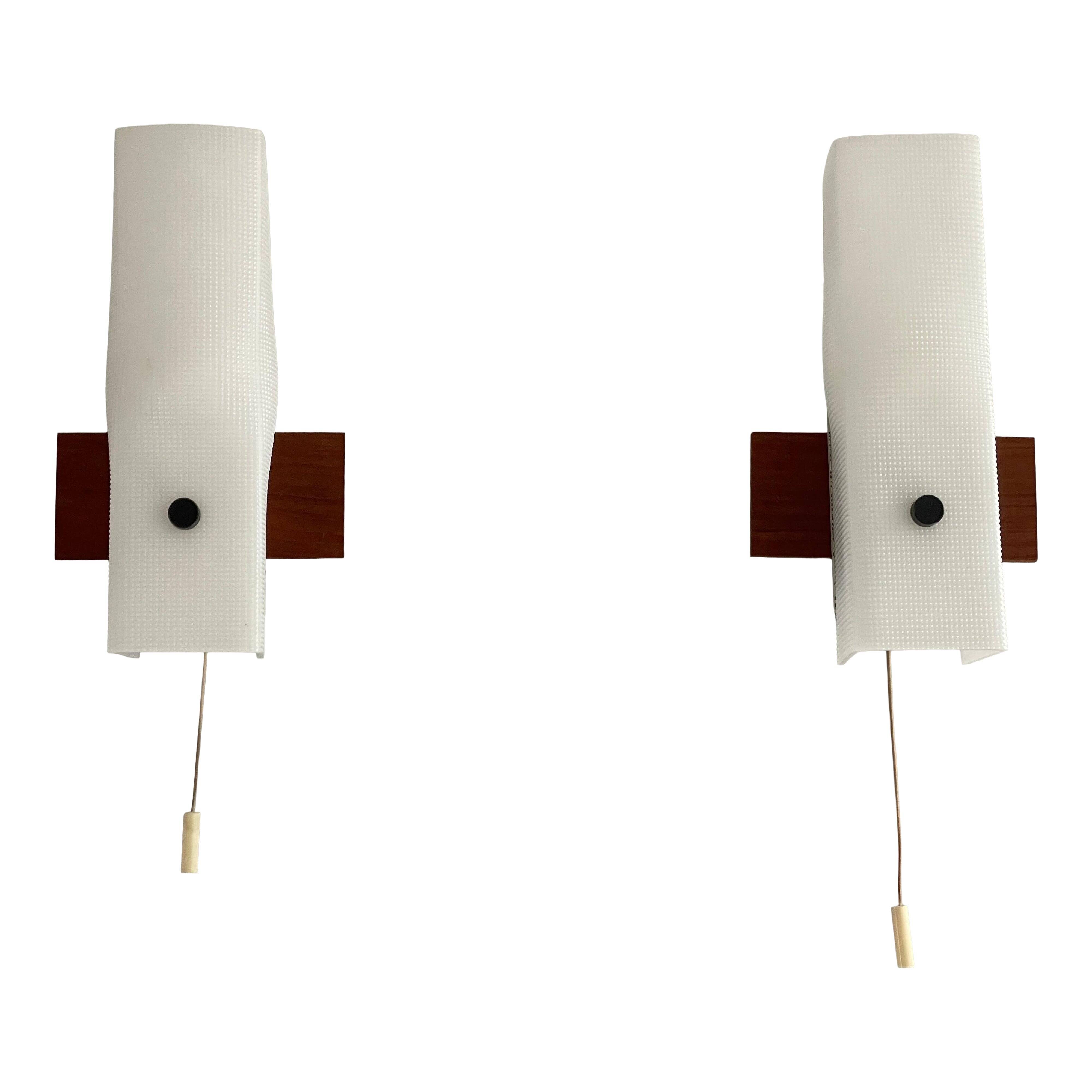 Mid-century wall lights in white plexiglass with a wooden base, 1960s, Germany.