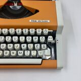 WE typewriter orange