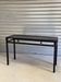 Black metal console with a glass top