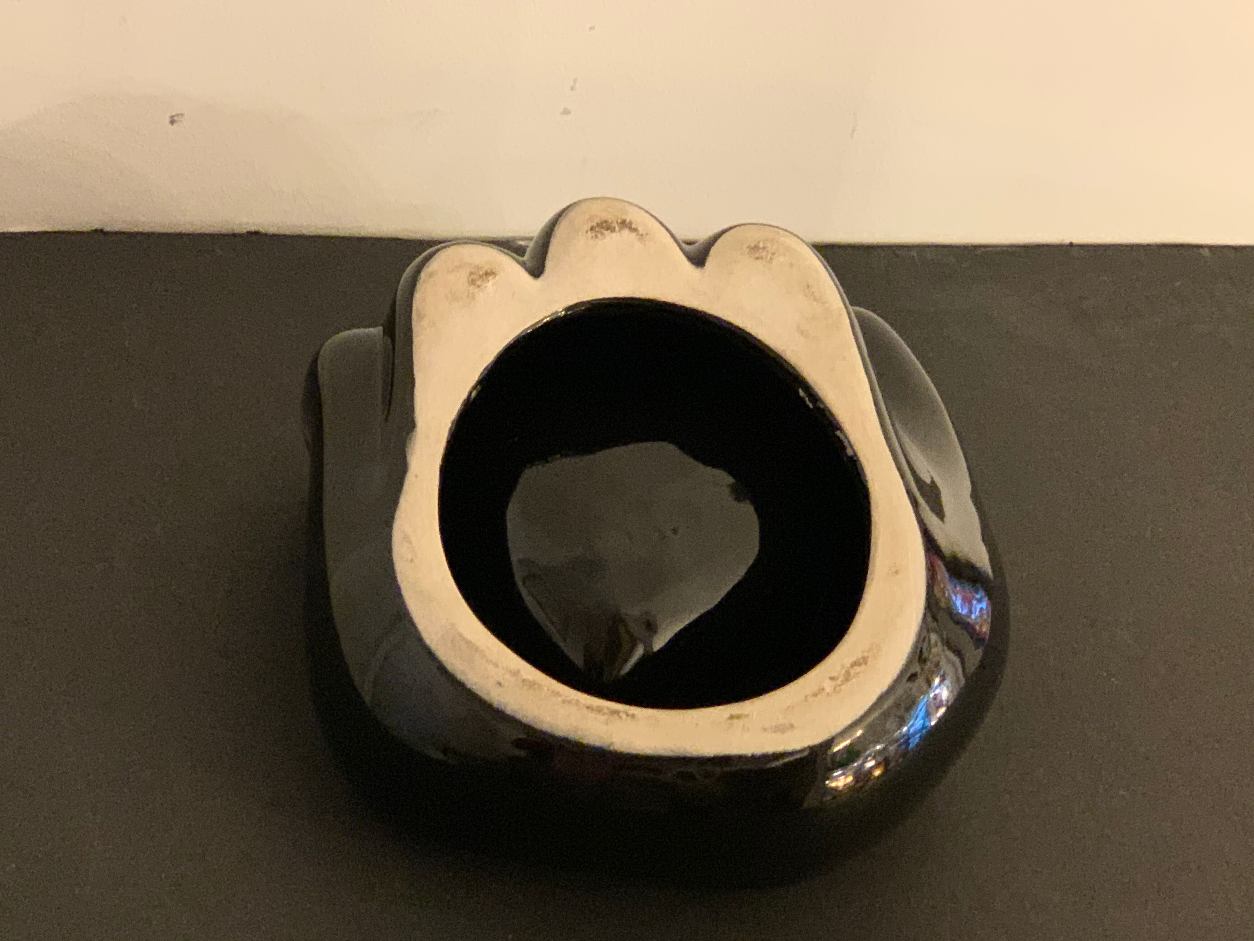 Black ceramic ashtray left hand