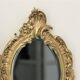 Pair of louis XV beveled mirror wall lamps in bronze by "Lucien Gau"