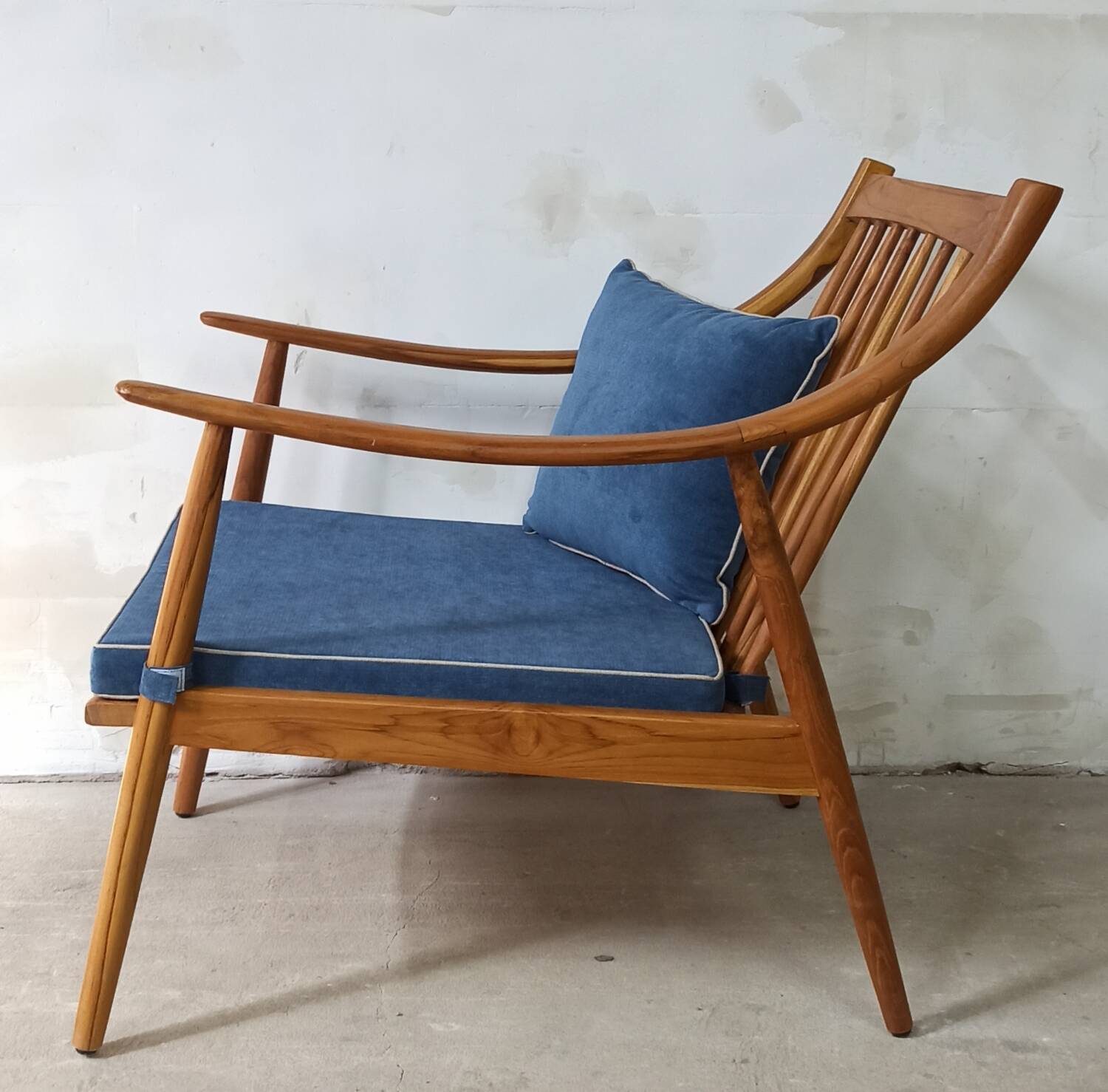 Pair of cozy teak armchairs with cushions