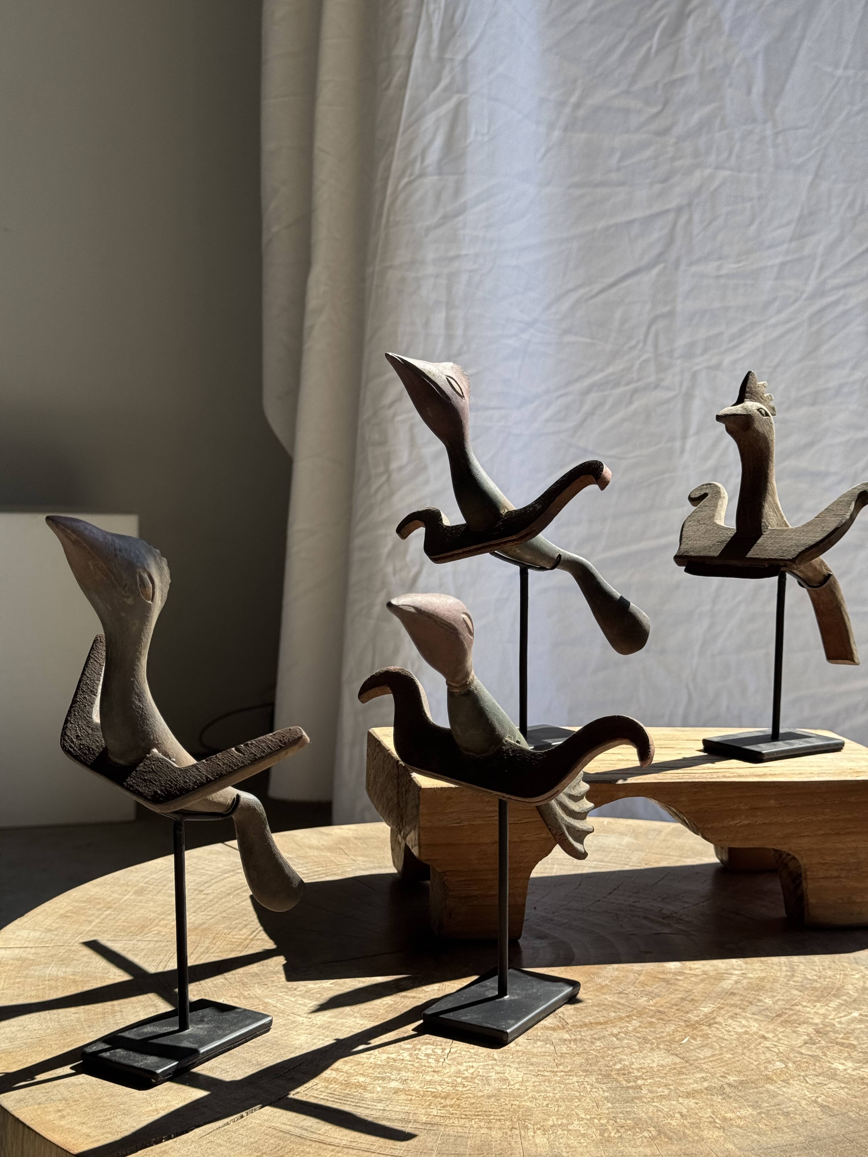 Traditional Indonesian decorative wooden bird on a base, crest model.