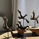 Traditional Indonesian decorative wooden bird on a base, crest model.