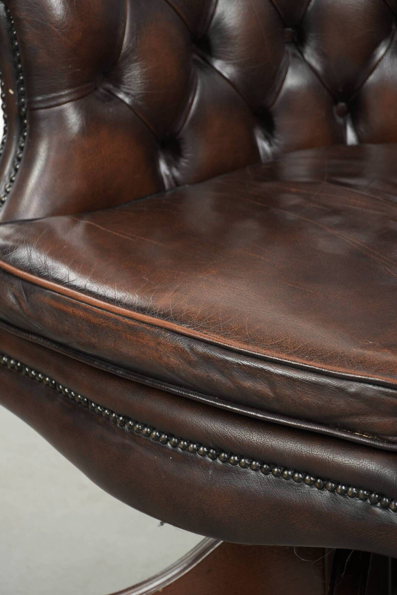Brown cow leather Chesterfield office chair on wheels in English style