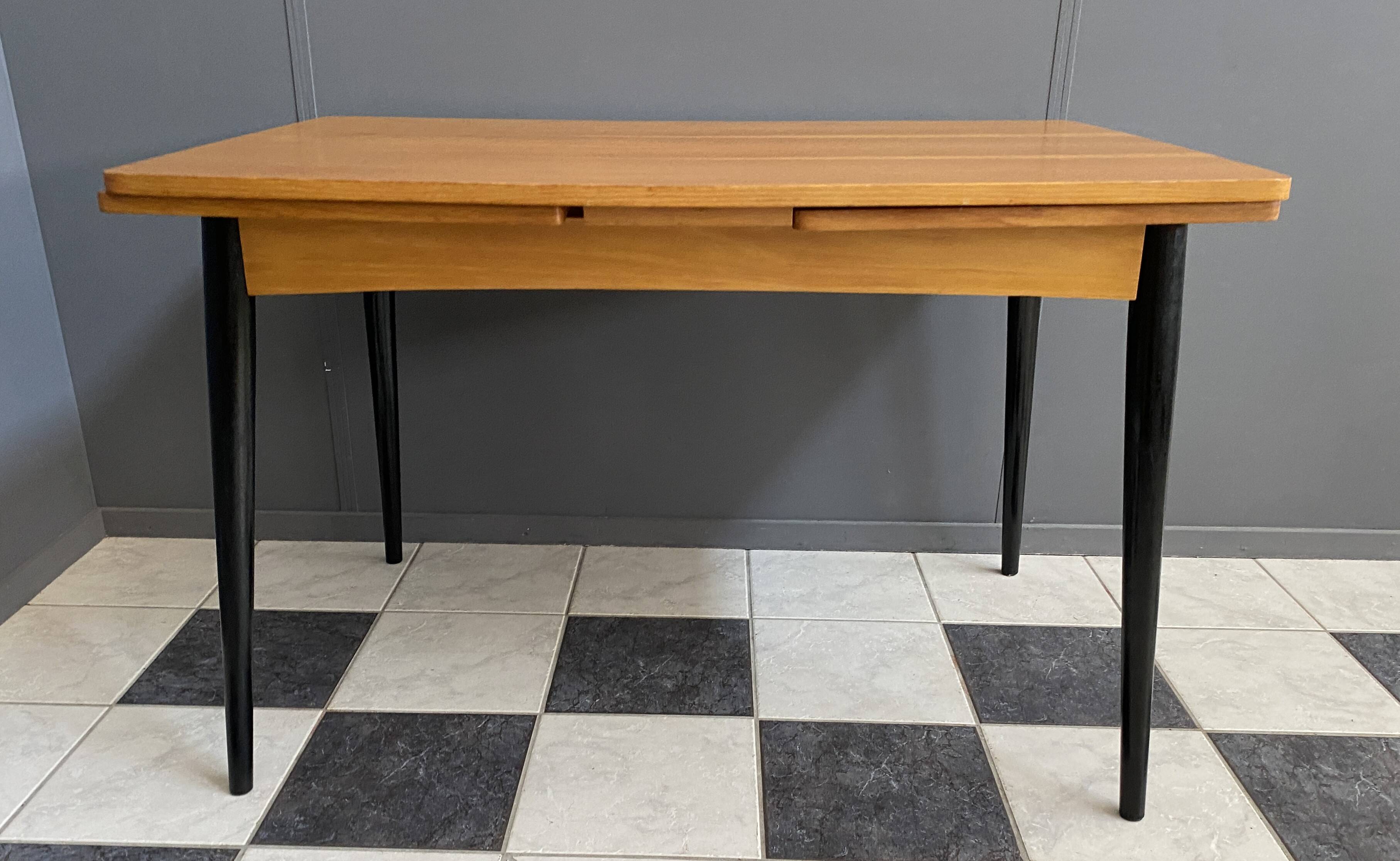 Wood enlarging dining table black wood legs 1960s