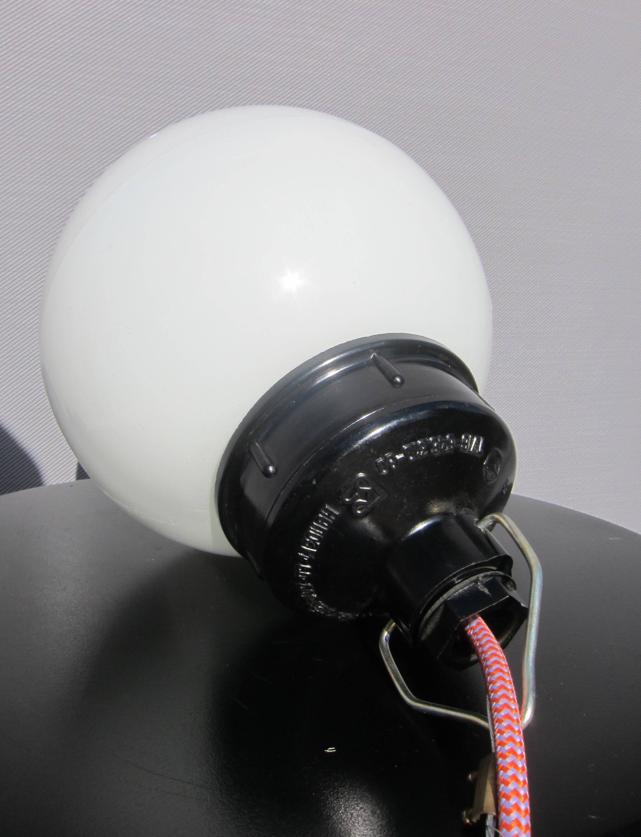 Trio of opal glass and bakelite globe pendant lights