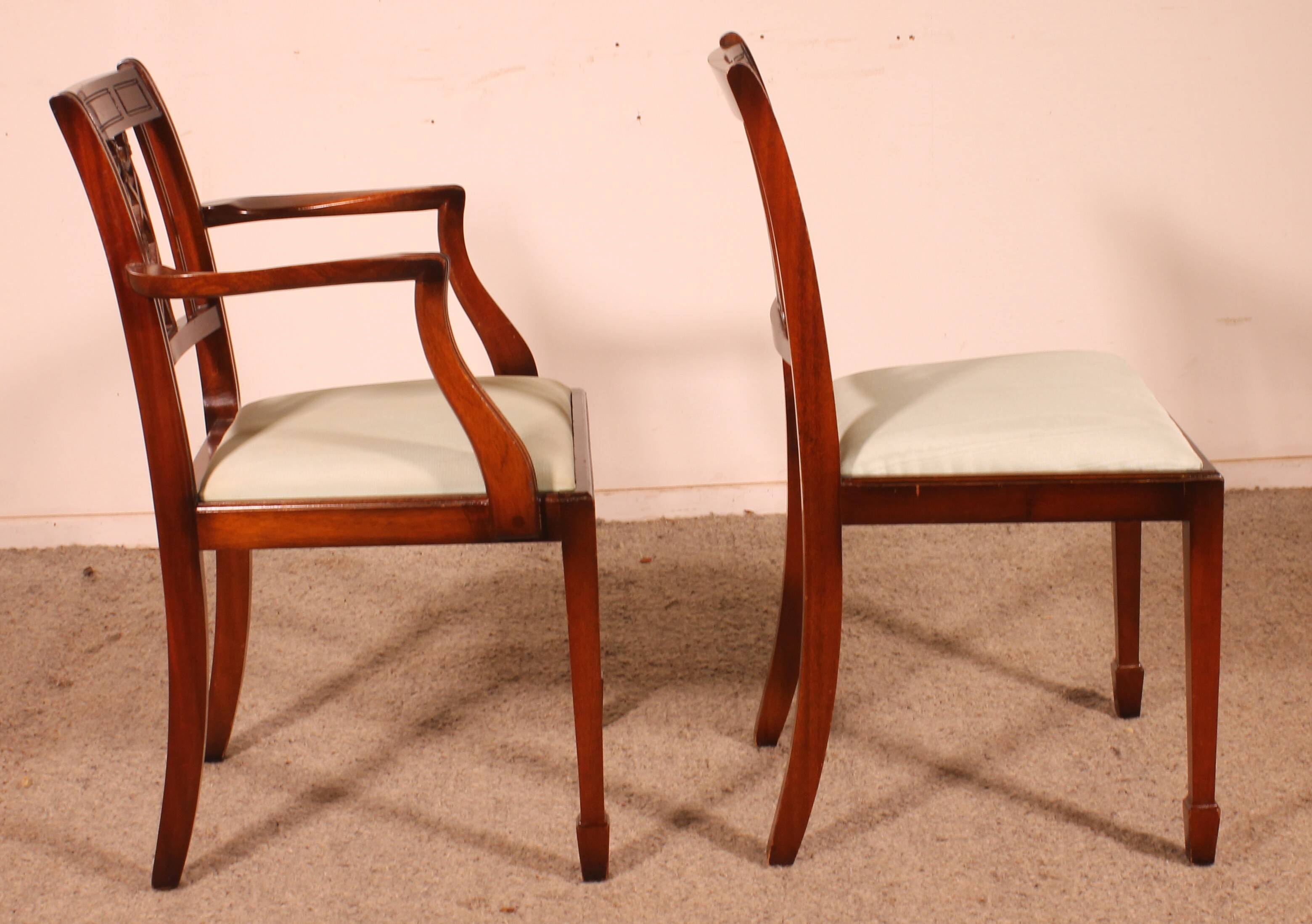 set of 10 chairs and two mahogany armchairs in Hepplewhite style