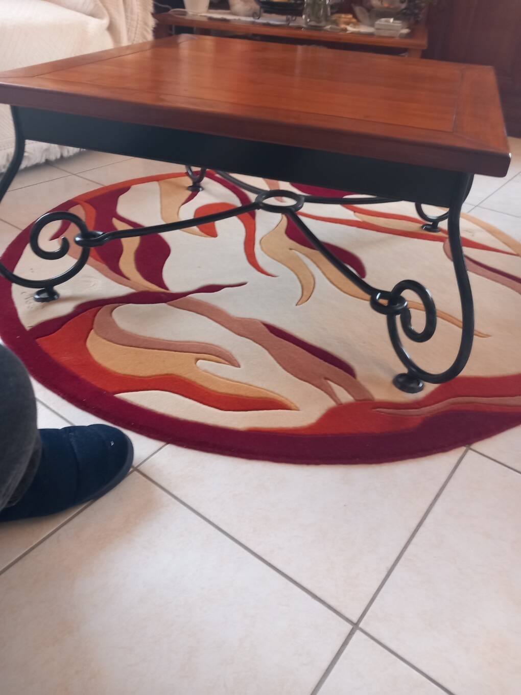 Coffee table in cherry wood with a wrought iron base.