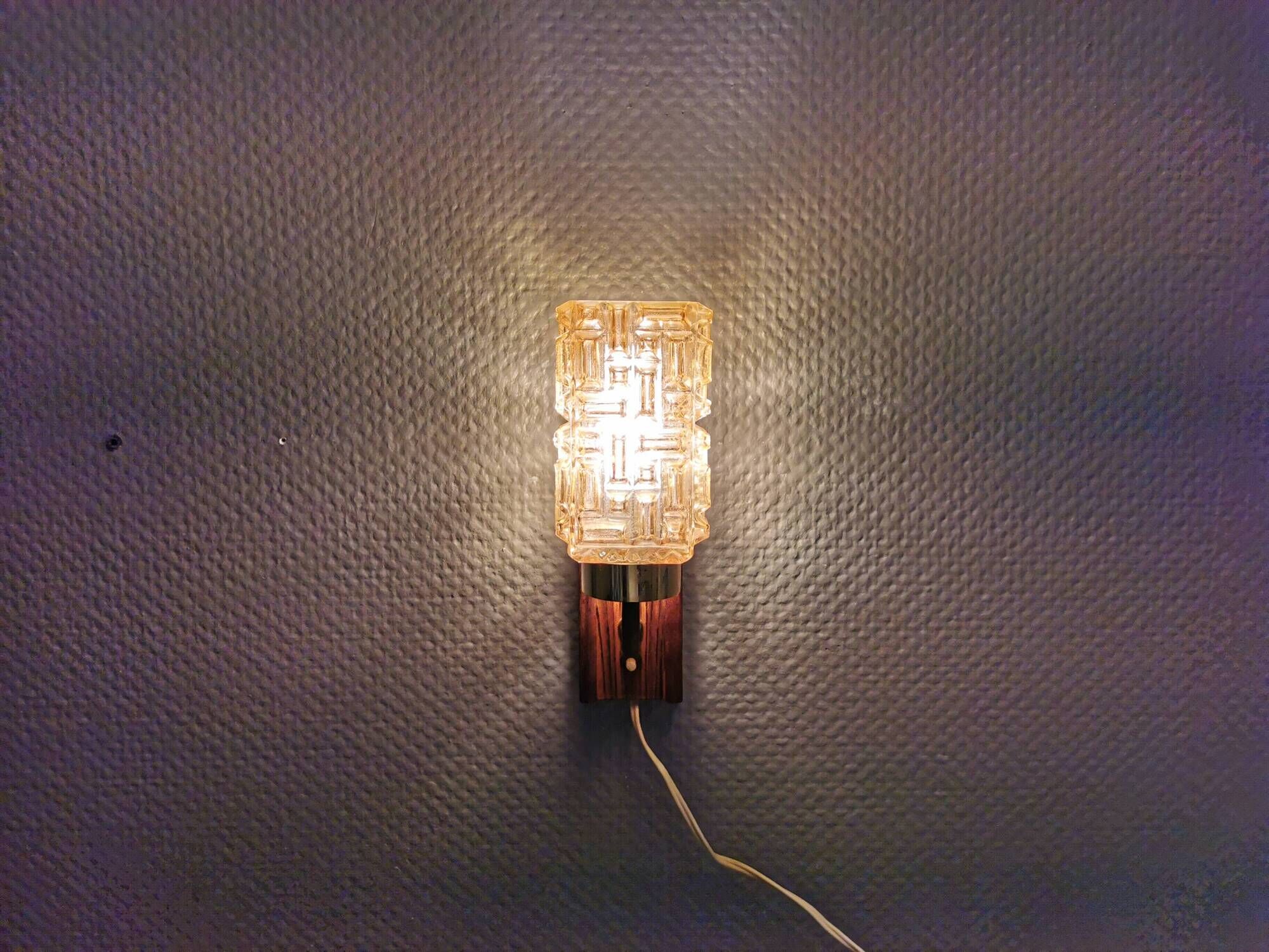 wall lights in rosewood look, with amber coloured glass and brass details.