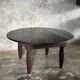 Antique round coffee table in Indonesian teak with turned legs.