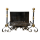 Pair of wrought iron and brass fire dogs with a log holder, 19th century.