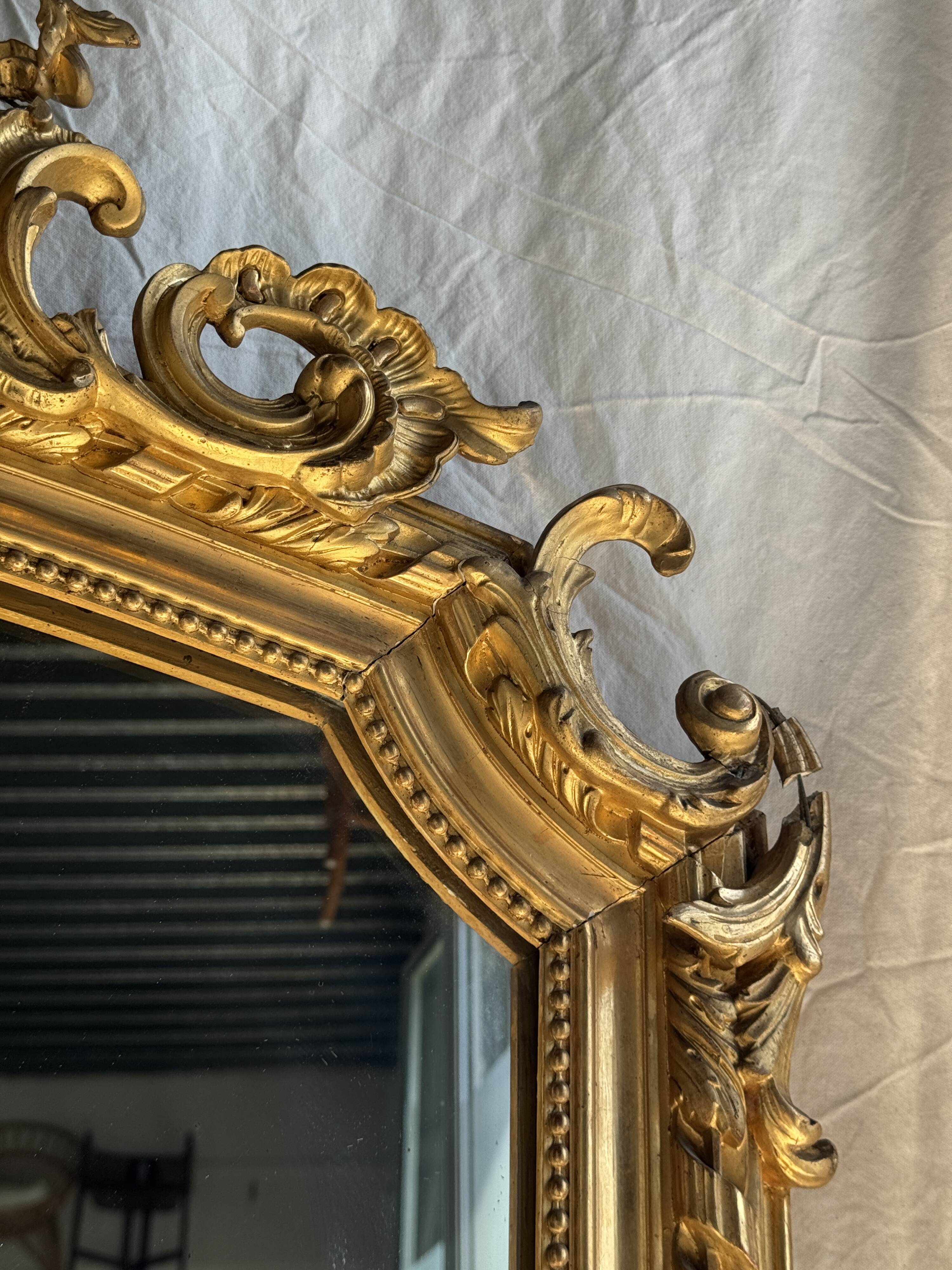Large gilded mirror with acanthus leaf pediment H150 L98