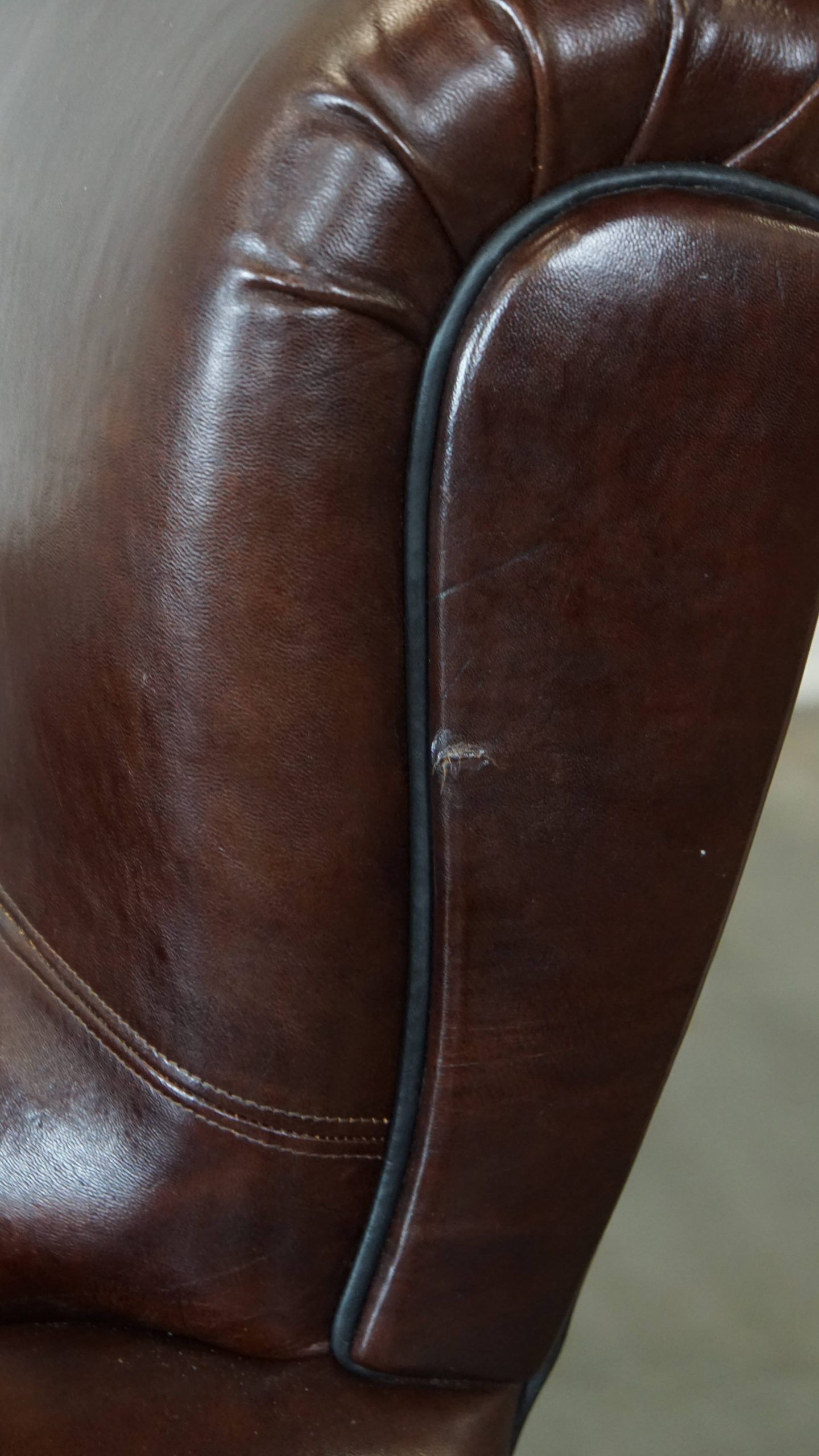 Comfortable and correct dark antique sheepskin English armchair in very good condition