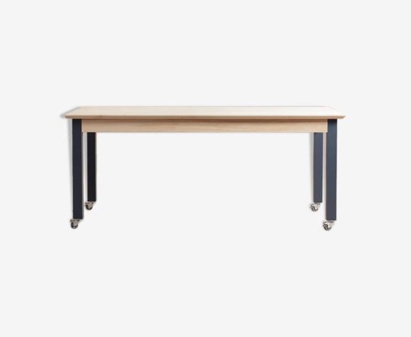 Custom-made dining table in solid beech with side extensions, legs on rotating wheels