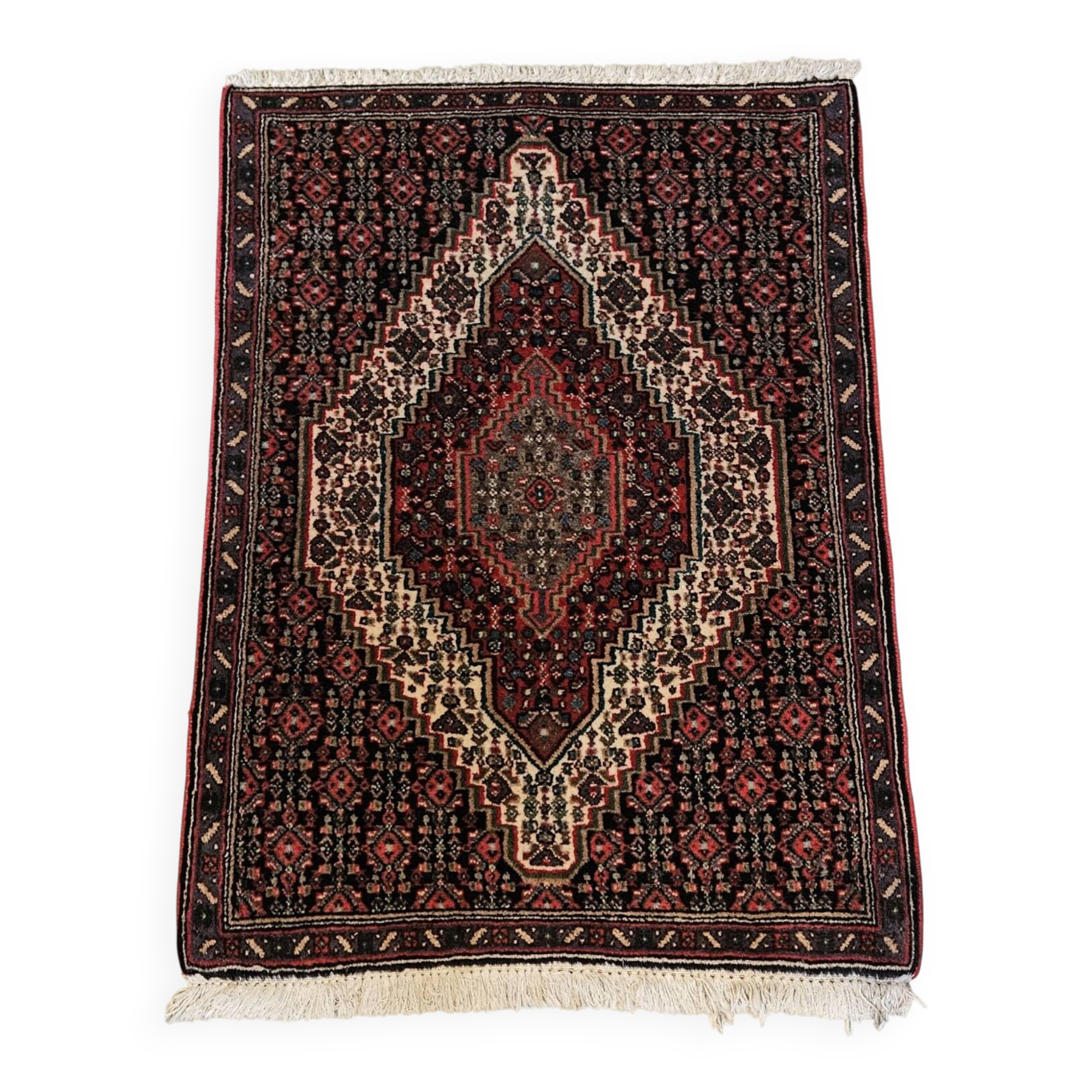 Ancient Persian carpet, wool, red tones, hand-knotted.