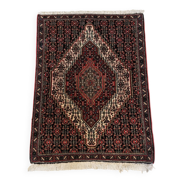 Antique Persian carpet, wool, red tones, hand-knotted.