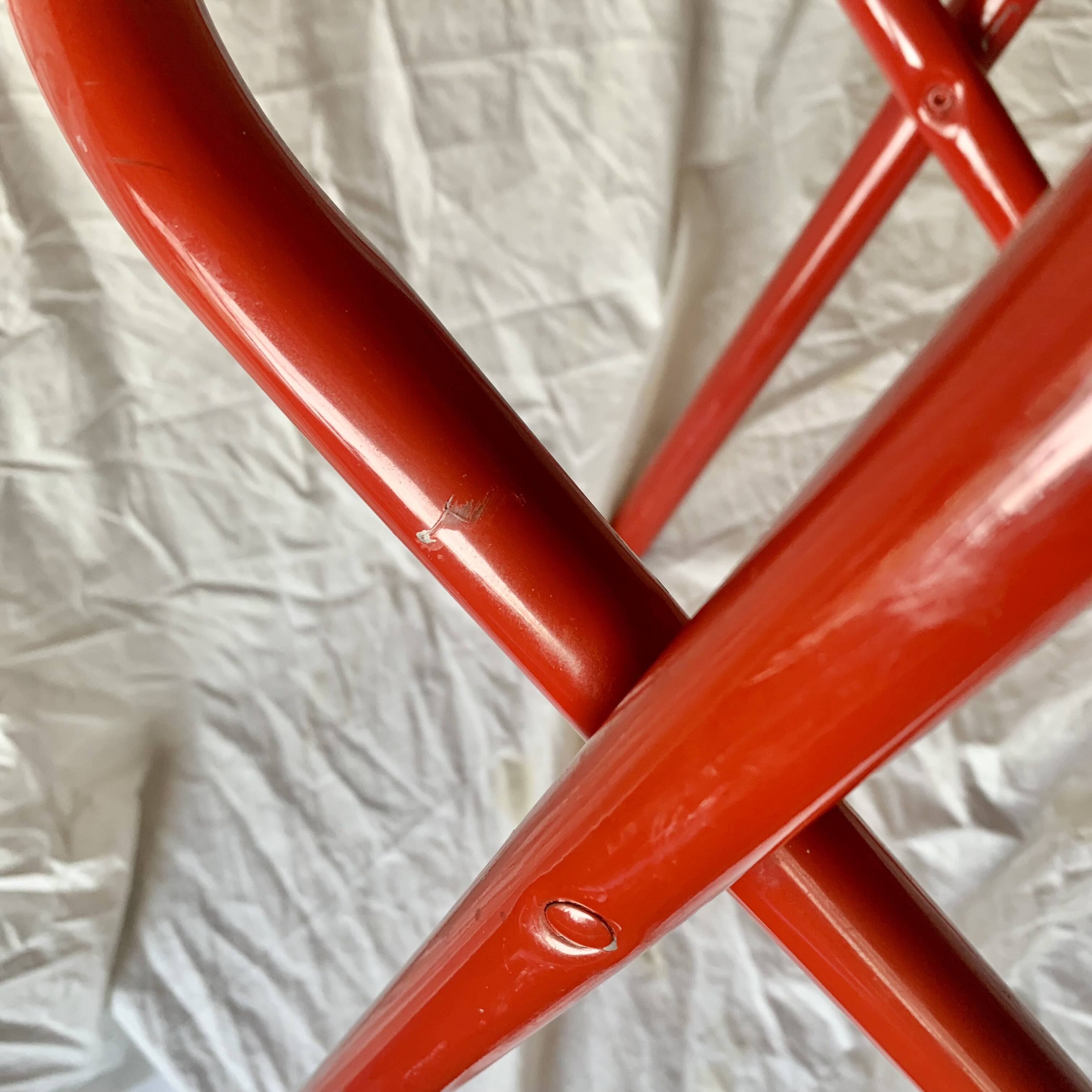 Vintage folding chair in red painted metal and wood