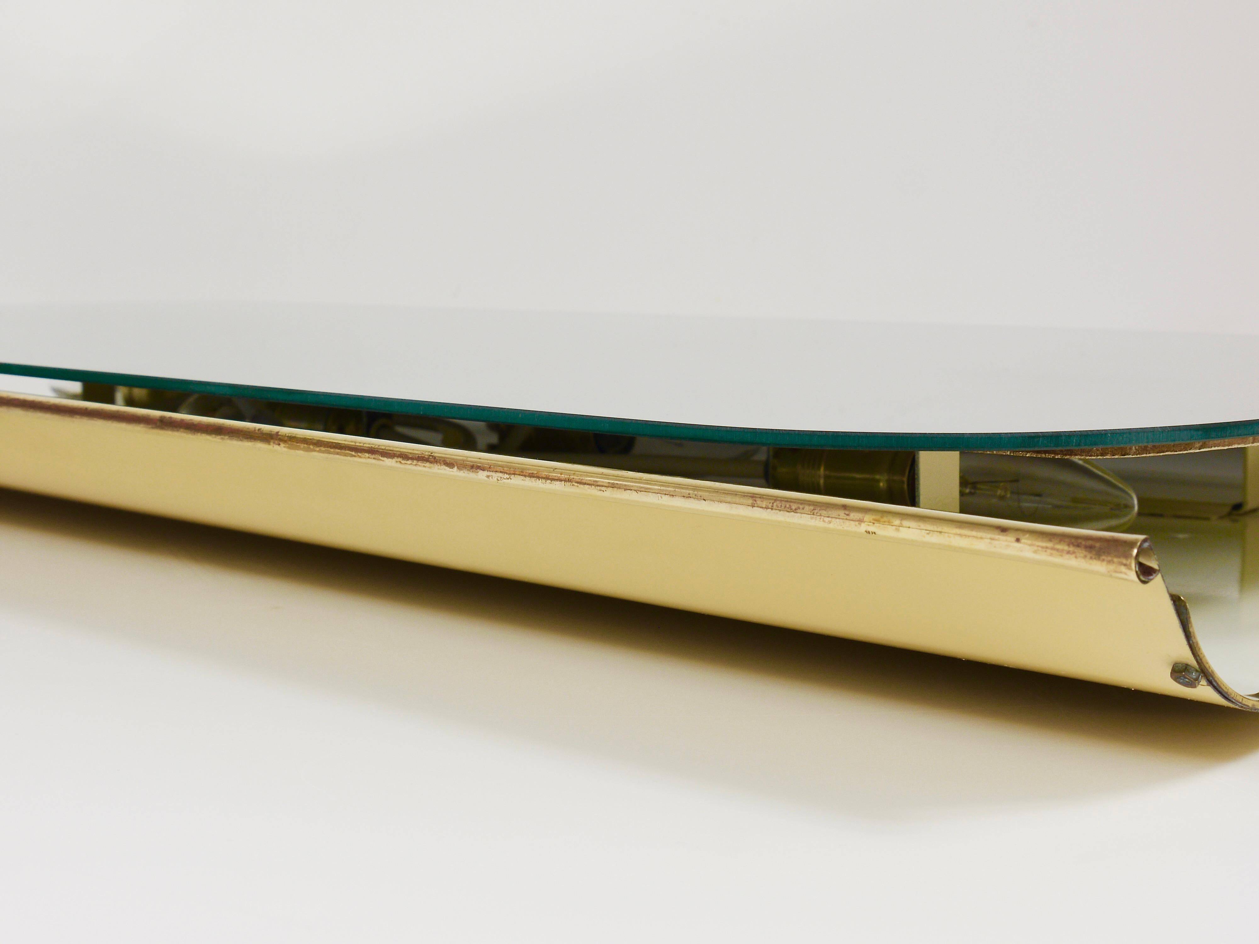 Mid-century illuminated wall mirror by Ernest Igl with brass crown, by Hillebrand.