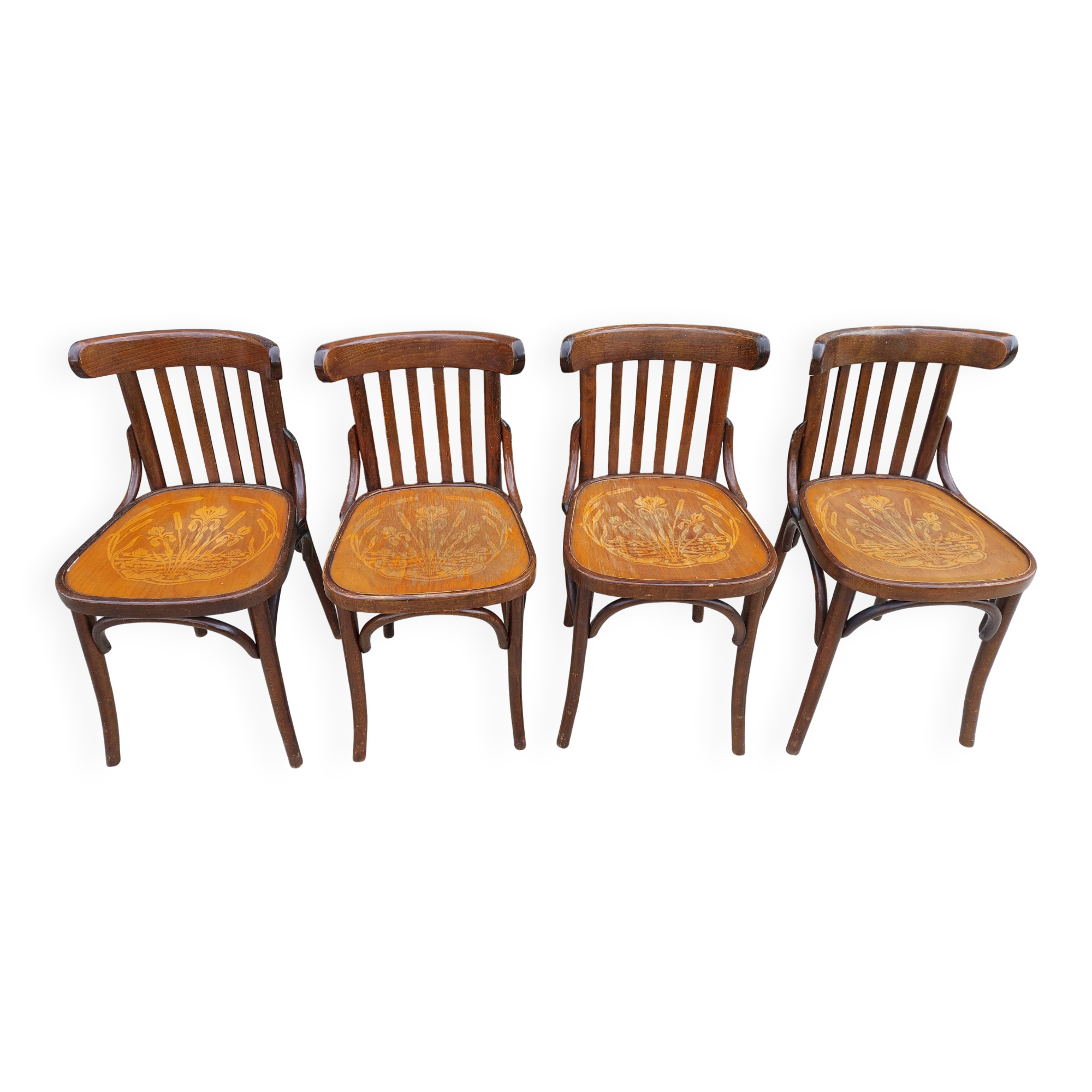 4 bentwood bistro chairs with a pattern on the seat
