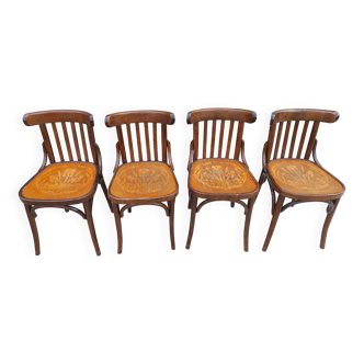 4 bentwood bistro chairs with a pattern on the seat