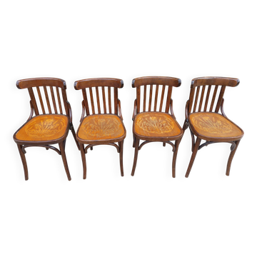 4 bentwood bistro chairs with a pattern on the seat