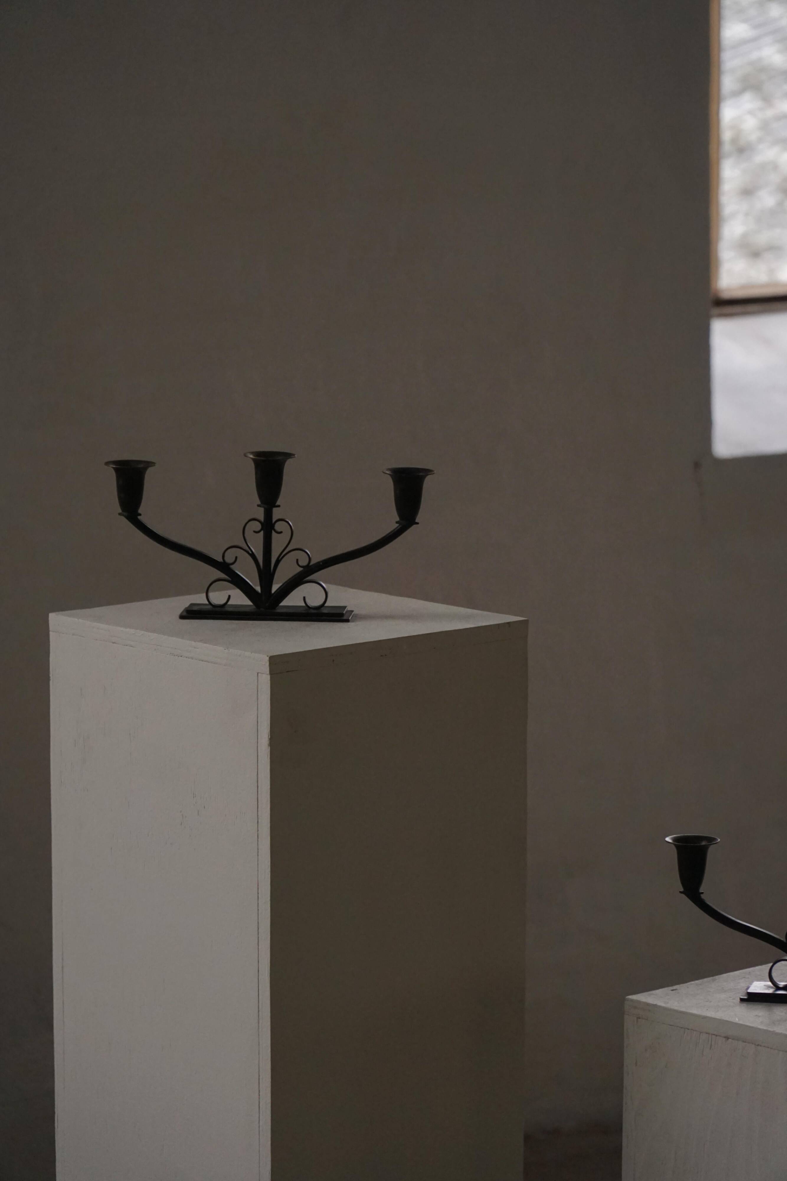Early 20th century, pair of Danish Art Deco candlesticks in metal with three arms, 1930s.