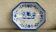 Antique octagonal plate in blue and white pottery with bird decoration.