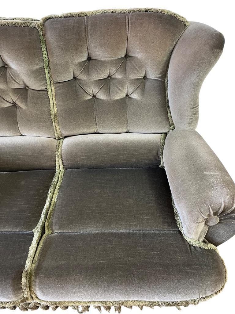 Vintage green two-seater sofa with fringes